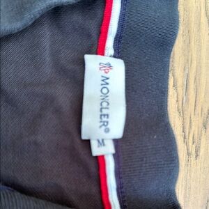 Moncler Black Garment with Red and White Accents Pre owned